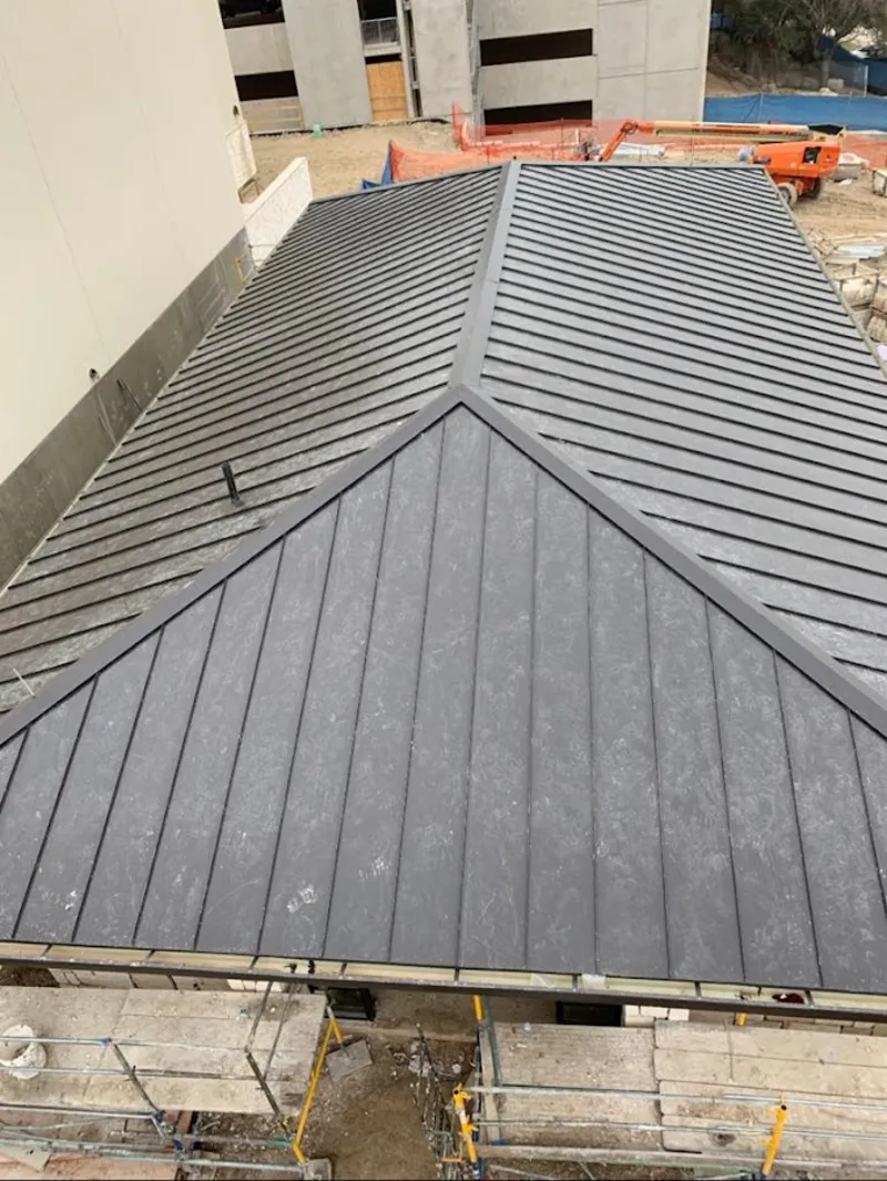 Commercial metal roof construction with crane equipment in South Brooksville